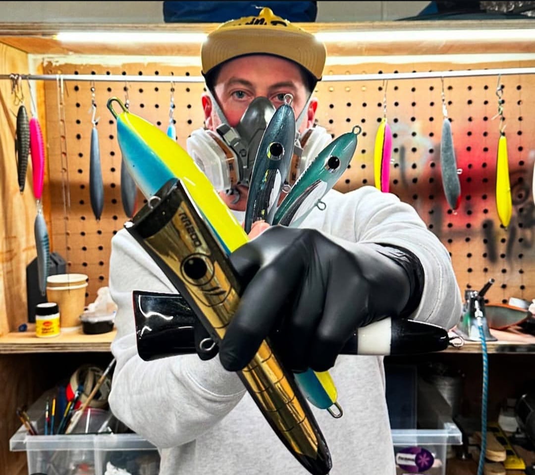 Mayday lure maker holding finished lures in the workshop