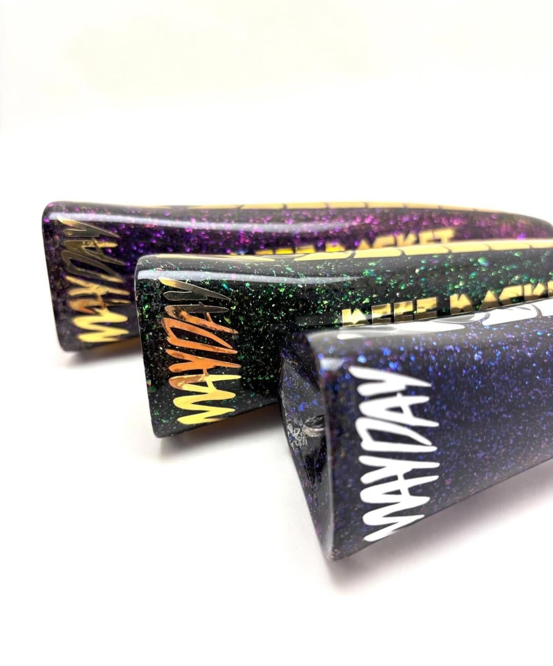 Close-up of Mayday-branded poppers in different finishes